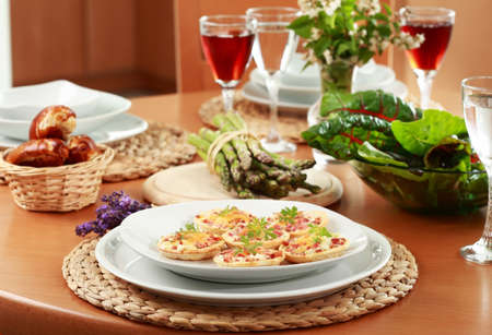 Small cheesy cakes as appetizer on the tableの写真素材