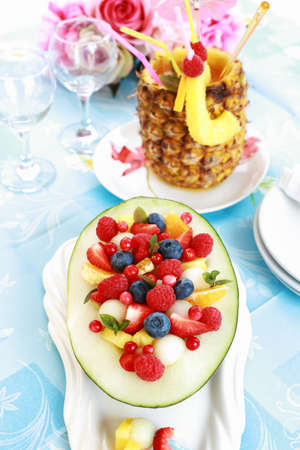 Delicious fresh fruit salad served in melon bowl as dessertの写真素材