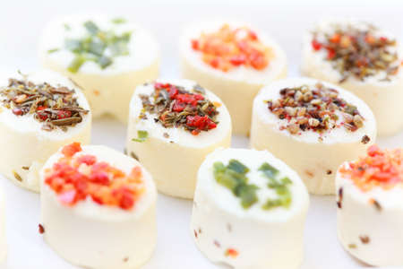 Delicious appetizer - cream cheese with different minced herbs and vegetablesの写真素材