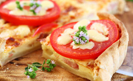 Tradition French bacon quiche with onion, tomato and cheeseの写真素材