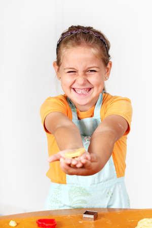 Cute girl baking cookies for Christmasの写真素材