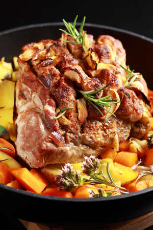 Tasty roasted pork meat with western potatoes and vegetable の写真素材