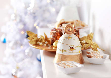 Christmas decoration with the bell and Christmas tree in backgroundの写真素材