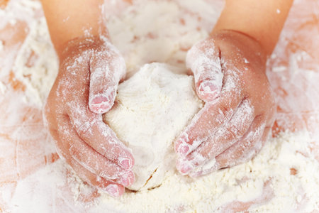 Detail of hands kneading dough