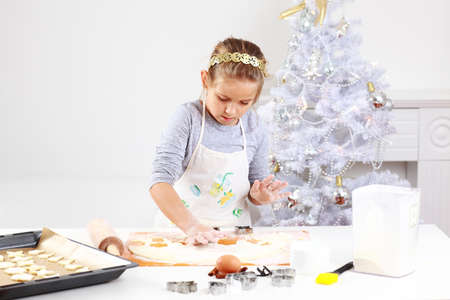 Cute girl baking cookies for Christmasの写真素材