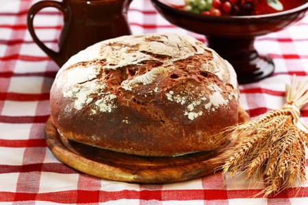 Loaf of rustic bread on black background