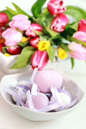 Easter eggs with tulips as table decorationの写真素材