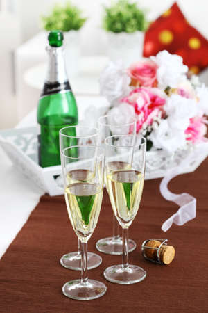 Sparkling wine with bouquet and wine bottleの写真素材
