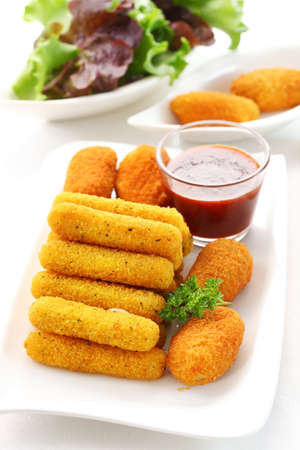 Fried cheese sticks - mozzarella and chilli pepper filled with cheese and tomato sauceの写真素材
