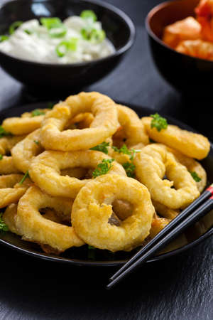 Fried calamari rings with yogurt garlic dipの写真素材
