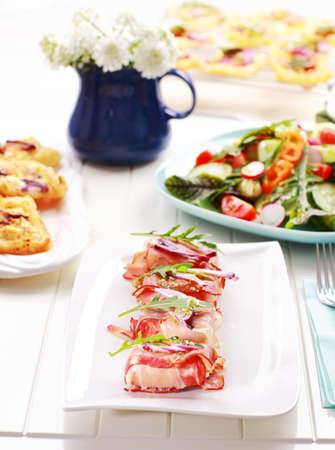 Prosciutto rolls filled with cheese and arugulaの写真素材