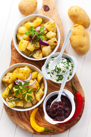 Baked potatoes with chutney and sour cream - top viewの写真素材
