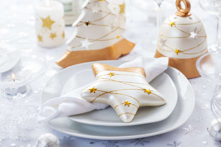 Festive table for Christmas in white and golden tonesの写真素材
