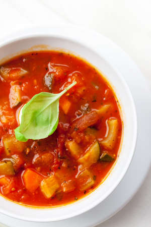 Homemade delicious minestrone soup with mozzarella and basilの写真素材