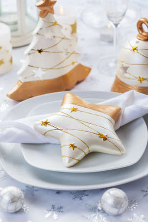 Festive table for Christmas in white and golden tonesの写真素材