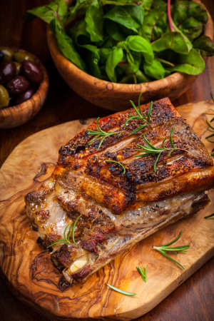 Roasted pork with olives and salad の写真素材
