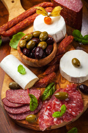Appetizer catering platter with different meat and cheese productsの写真素材