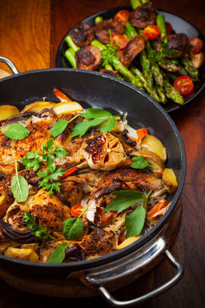 Roasted roasted rabbit on vegetables in panの写真素材