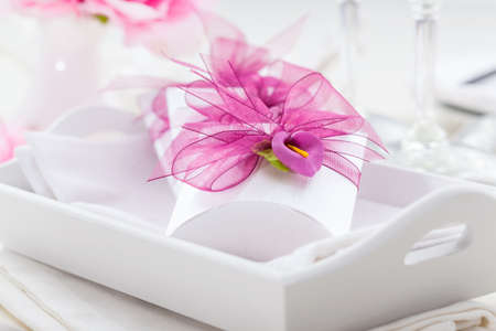 Decorated table in white with small present for the guestsの写真素材