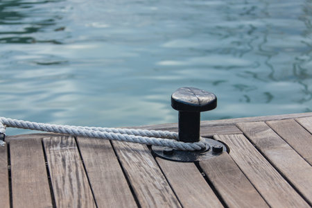 Yachting - Mooring rope tied around steel anchor