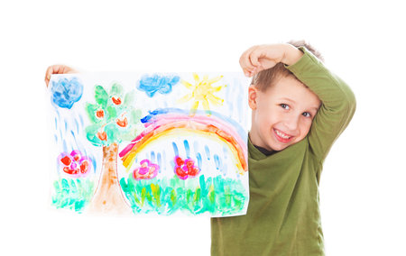 Happy boy showing his paintingの写真素材