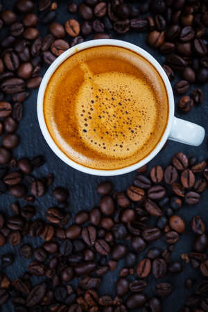 Cup of espresso with coffee beans - top viewの写真素材