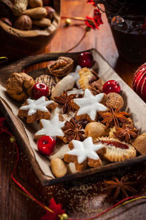 Homemade gingerbread and cookies for Christmas on wooden plateの写真素材