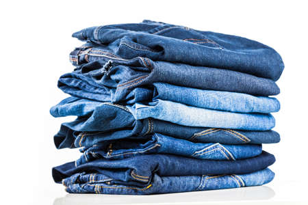 Stack of blue jeans on whiteの写真素材
