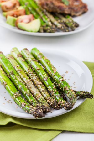 Glazed green asparagus with sesame seedsの写真素材