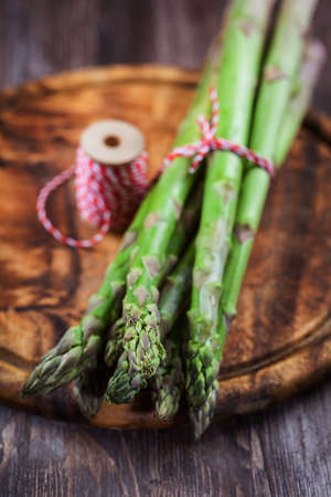 Fresh green asparagus on wooden tableの写真素材