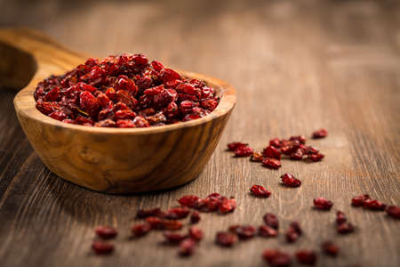 Dried Barberry (Berberis vulgaris) on wooden tableの写真素材