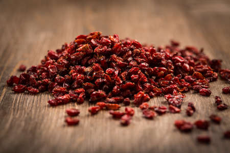 Dried Barberry (Berberis vulgaris) on wooden tableの写真素材
