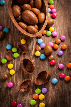 Assorted chocolate eggs for Easter on wooden backgroundの写真素材