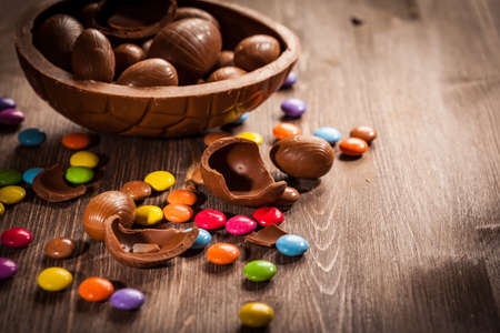 Assorted chocolate eggs for Easter on wooden backgroundの写真素材
