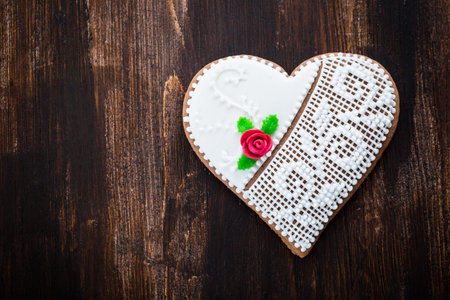 Traditional gingerbread heart cookie on wooden backgroundの写真素材
