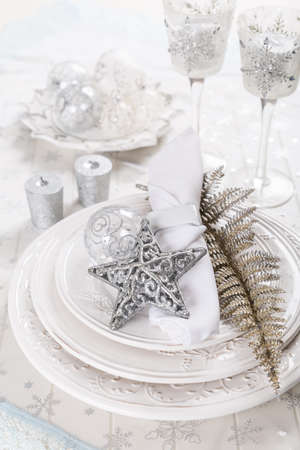 Festive table setting for Xmas with silver star on plateの写真素材