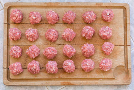 Raw meatballs of Iberico pork on the cutting board prepared for cookingの写真素材