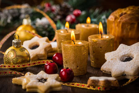 Christmas still life with homemade cookies and candles on wooden backgroundの写真素材