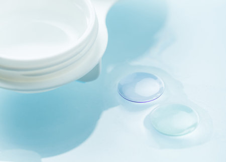 Macro detail of modern rigid gas permeable contact lenses (GP) in storage solution and storage case