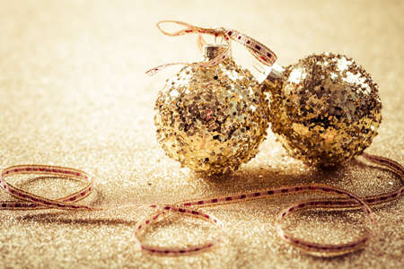 Golden christmas balls on glitterの写真素材