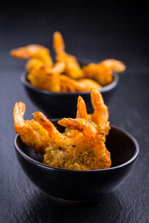 Roastet and breaded hot Thai shrimps with dipの写真素材