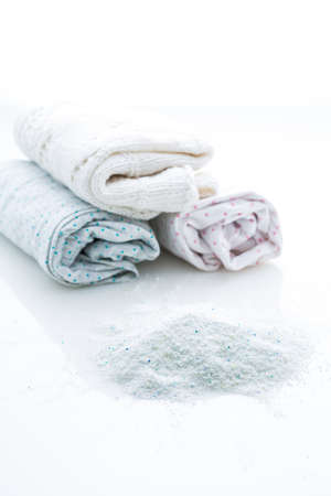 Laundry - Washing powder with clothes isolated on white backgroundの写真素材