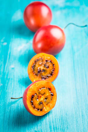 Fresh tamarillo fruit on wooden backgroundの写真素材