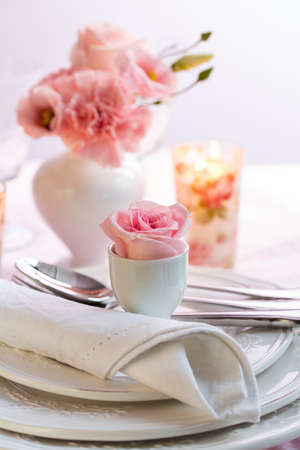 Place setting with beautiful bouquet in vase in pink and white on the kitchen tableの写真素材