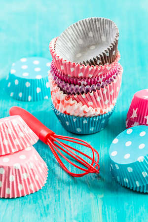 Variation of small paper forms for baking cupcakes and muffins with wisp. Colorful paper liners.の写真素材