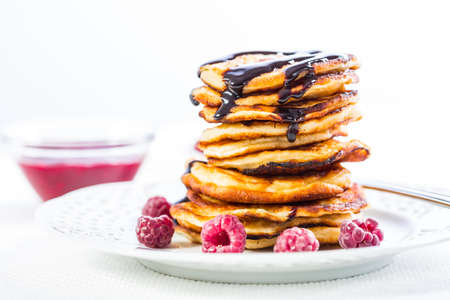 Delicious cottage cheese pancakes with fresh raspberry and chocolate sirup. Curd fritters.の写真素材