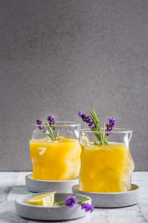 Summer orange and lemon cocktail with fresh lavender and rosemary. Summer lemonade with herbs.の写真素材