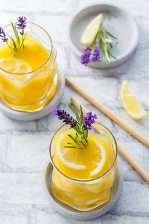 Summer orange and lemon cocktail with fresh lavender and rosemary. Summer lemonade with herbs.の写真素材