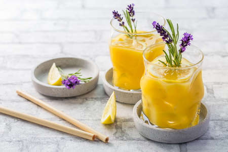 Summer orange and lemon cocktail with fresh lavender and rosemary. Summer lemonade with herbs.の写真素材