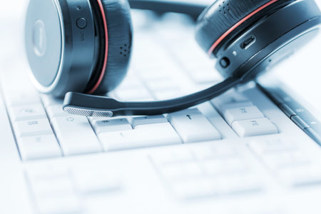 Concept of communication support, call center and customer service help desk. Headphones on...